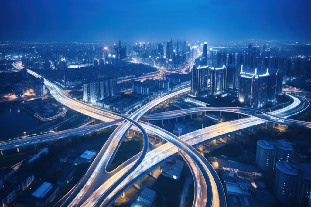 A street at night with vehicles and highways.