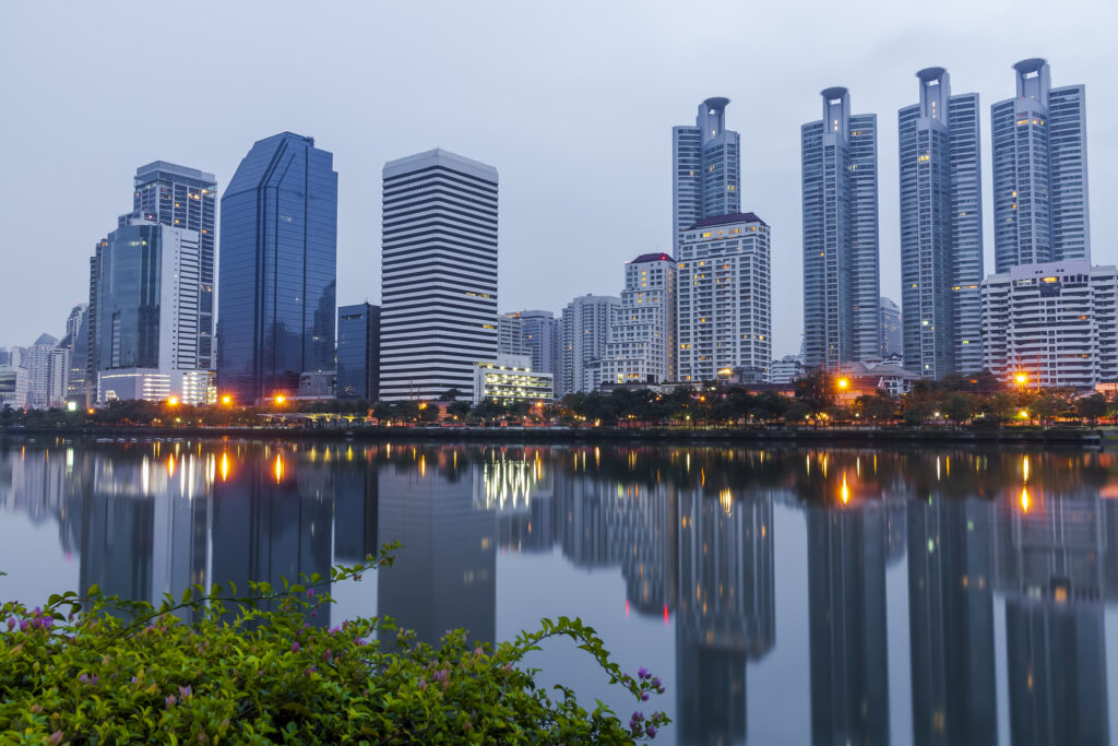 Modern office building or tower in Bangkok Thailand business center at twilight nature blue toned